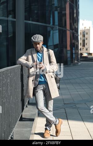 African businessman using smart phone while standing in the city Stock Photo