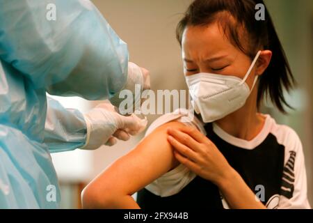 Phnom Penh, Cambodia. 26th May, 2021. A woman receives her second dose of Sinovac COVID-19 vaccine at a vaccination site in Phnom Penh, Cambodia, on May 26, 2021. Cambodia on Wednesday confirmed 660 new COVID-19 cases in the last 24 hours, pushing the national tally to 26,989, the Ministry of Health (MoH) said in a statement. Credit: Phearum/Xinhua/Alamy Live News Stock Photo