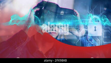 Composition of blue light trails and online security padlock over man wearing vr headset Stock Photo