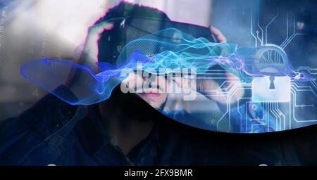 Composition of blue light trails and online security padlock over man wearing vr headset Stock Photo