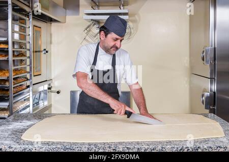 Stages of preparation, pastry chef prepares jam croissant in pastry shop Stock Photo