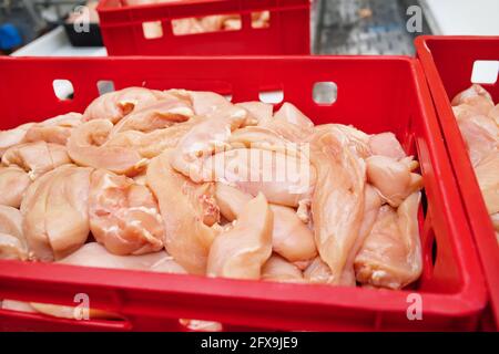 Food products meat chicken in plastic packaging on the conveyor.Chicken fillet production line . Factory for the production of food from meat.Conveyor Stock Photo