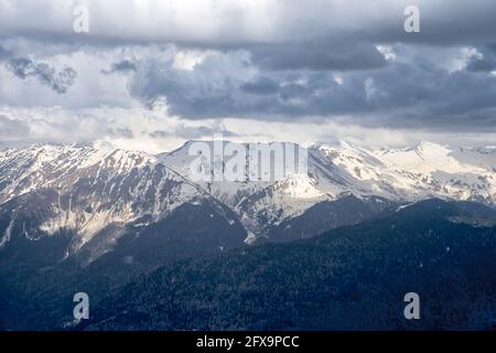 Mountain snow-capped peaks in the clouds. Tourist routes. Extreme tourism, extreme sports. Climbing the peaks. Stock Photo