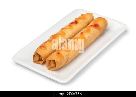 Plate with a pair of crispy deep fried Vietnamese egg rolls and sauce isolated on white background Stock Photo