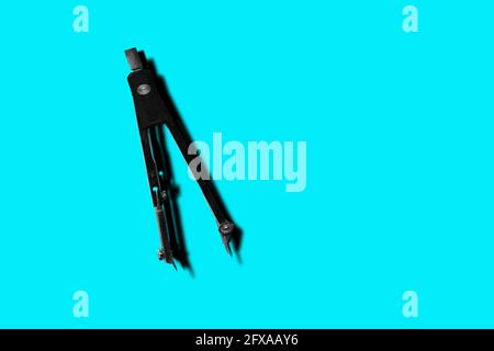 Pair of Compasses isolated on blue background Stock Photo