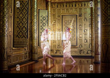 Thai traditional dress. Young kid Actors performs Thai ancient dancing Art of Thai classical dance in Thailand Stock Photo