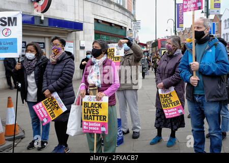 London, UK. 25/05/21. Anti-racism campaigners including local councillors mark George Floyd's death one year on with speeches and taking the knee. Stock Photo