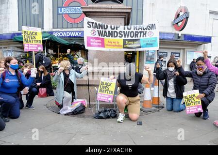 Anti-racism campaigners including local councillors 'take the knee' on the first anniversary of George Floyd's death in Tooting, South London. Stock Photo