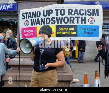 London, UK. 25/05/21. Anti-racism campaigners including local councillors mark George Floyd's death one year on with speeches and taking the knee. Stock Photo