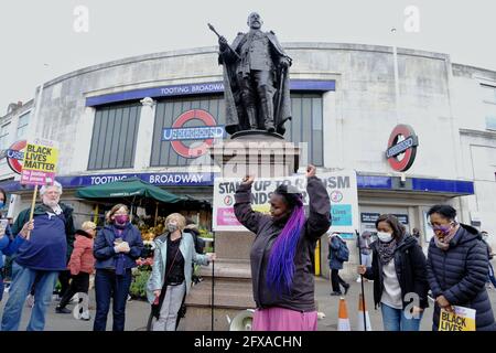 London, UK. 25/05/21. Anti-racism campaigners including local councillors mark George Floyd's death one year on with speeches and taking the knee. Stock Photo