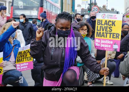 Anti-racism campaigners including local councillors 'take the knee' on the first anniversary of George Floyd's death in Tooting, South London. Stock Photo