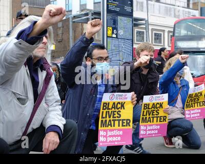 Anti-racism campaigners including local councillors 'take the knee' on the first anniversary of George Floyd's death in Tooting, South London. Stock Photo