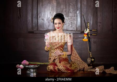 Beautyful Thai woman wearing thai traditional clothing, Beautiful woman, Thai national costume, traditional Thai dress, Thai woman, good mood Stock Photo