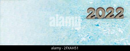 Banner 2022. Numerals 2022 on blue background. Wooden digits 2022. Stock Photo