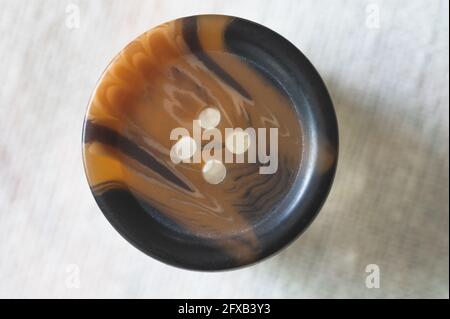 Brown and Black Button on White Background Stock Photo