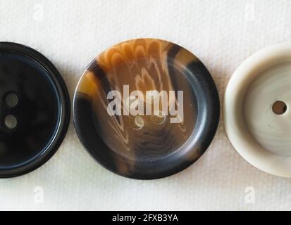 Black, Brown, and Tan Buttons on White Background Stock Photo