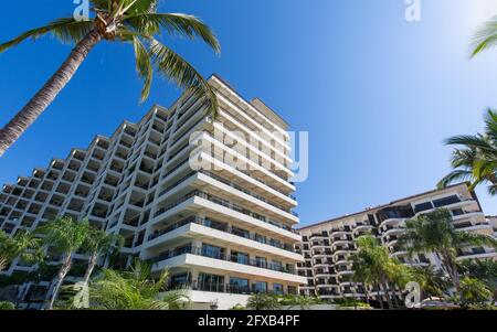 Luxury condominiums and apartments on Playa De Los Muertos beach and pier close to the famous Puerto Vallarta Malecon, the city largest public beach. Stock Photo