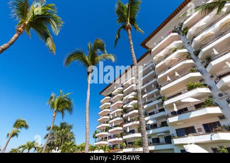 Luxury condominiums and apartments on Playa De Los Muertos beach and pier close to the famous Puerto Vallarta Malecon, the city largest public beach. Stock Photo