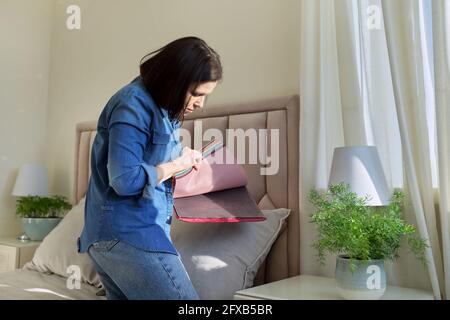 Woman with samples of interior fabrics choosing fabrics for upholstery, curtains Stock Photo
