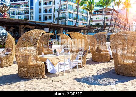 Restaurants and cafes with ocean views on Playa De Los Muertos beach and pier close to famous Puerto Vallarta Malecon, the city largest public beach. Stock Photo