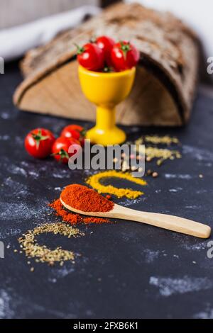 Spoon and paprika with cherry tomatoes Stock Photo