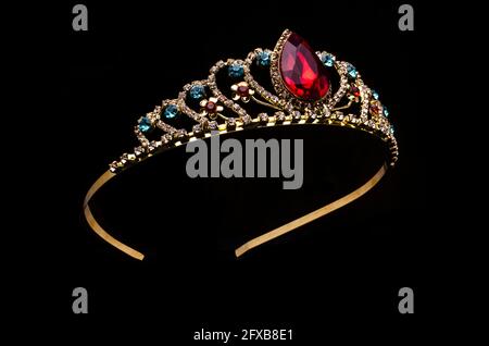 gold crown with red ruby stone isolated on black Stock Photo