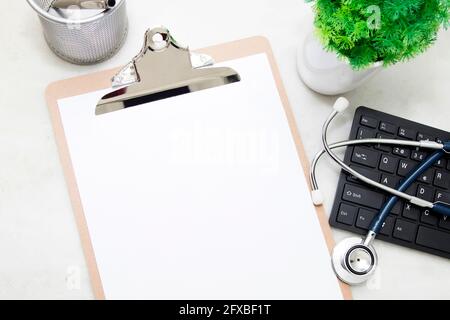 folder medical with the stethoscope and the computer on the desk, top view Stock Photo