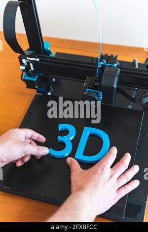Young male engineer working on 3D printer machinery Stock Photo