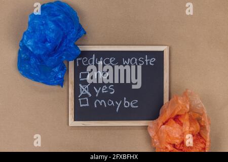 Studio shot of small blackboard and two plastic bags Stock Photo