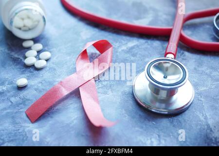 Black ribbon and stethoscope on white background. Melanoma concept ...