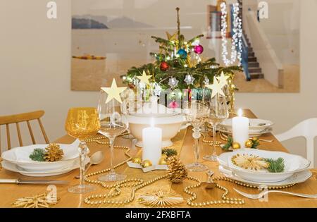 Festive Christmas table with small Christmas tree in background Stock Photo