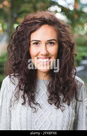 Curly haired woman smiling Stock Photo