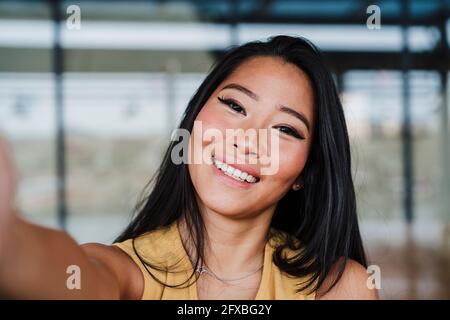 Female professional taking selfie at office Stock Photo