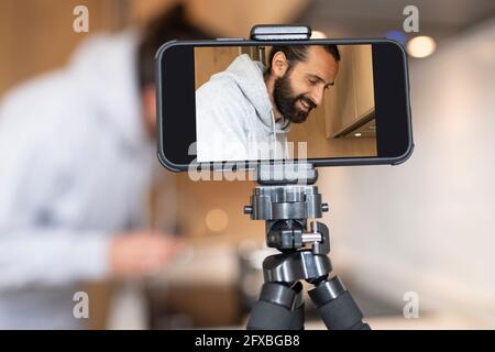 Man filming through smart phone at home Stock Photo