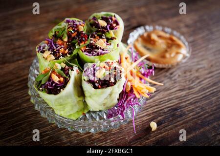Cabbage rolls with black rice, sesame seeds, carrot and red cabbage Stock Photo