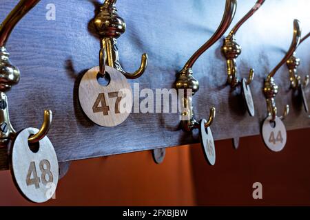 Number labels hanging on hooks in stage theater cloakroom Stock Photo