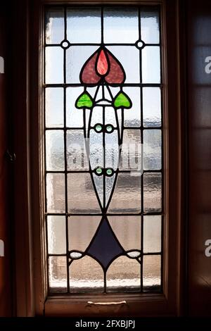 Art nouveau window with tulip design at the Rhu Inn, Scotland Stock Photo