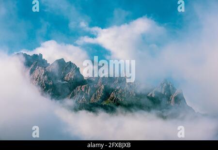 Clouds over mountain peaks in the Dolomites Stock Photo - Alamy