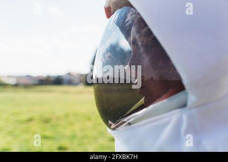 Female astronaut in space helmet looking away Stock Photo