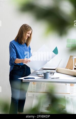 Businesswoman doing paperwork in office Stock Photo