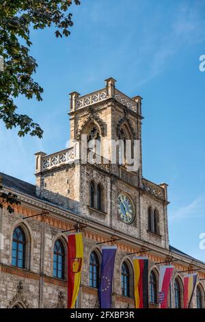 Germany, Thuringia, Weimar, Town hall with clock, carillon and flags Stock Photo