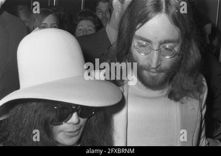 John Lennon and wife Yoko Ono leave the Hilton Hotel in Amsterdam, March 31, 1969, arrival and departure, couples, musicians, The Netherlands, 20th century press agency photo, news to remember, documentary, historic photography 1945-1990, visual stories, human history of the Twentieth Century, capturing moments in time Stock Photo