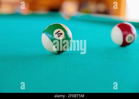 Playing with striped balls on a billiard table. Close-up. Stock Photo