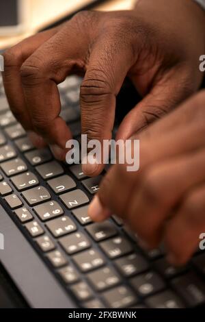 Man typing on keyboard at office Stock Photo