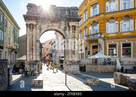 Croatia, Istria County, Pula, Sun shining over Arch of Sergii Stock Photo