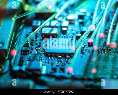 Fibre optics carrying data passing through laptop for cyber security Stock Photo