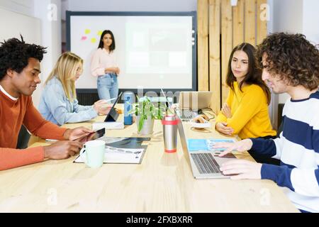 Business professionals using technologies at board room in office Stock Photo