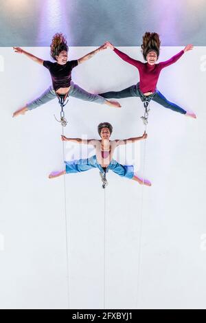 Multi-ethnic female dancers doing rehearsal together on rope in dance studio Stock Photo