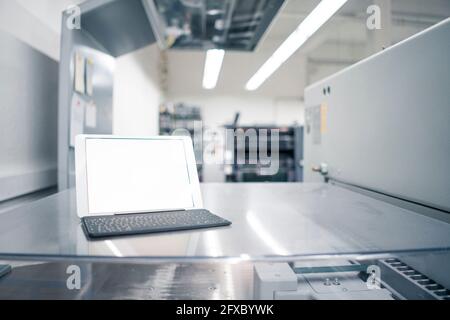 Digital tablet on glass table in industry Stock Photo