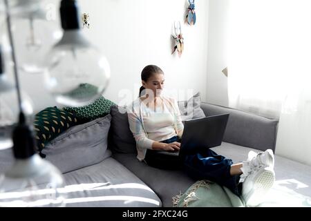 Mature woman using laptop while working at home Stock Photo